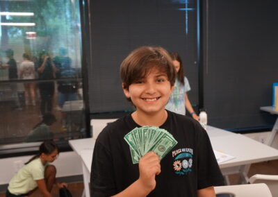 Kid showing "money" smiling